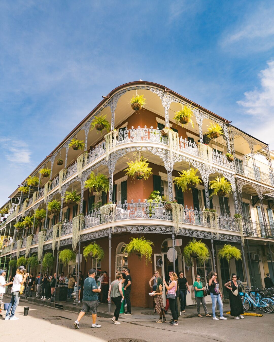A lively street scene in the French Quarter showcasing ornate balconies and vibrant décor.
